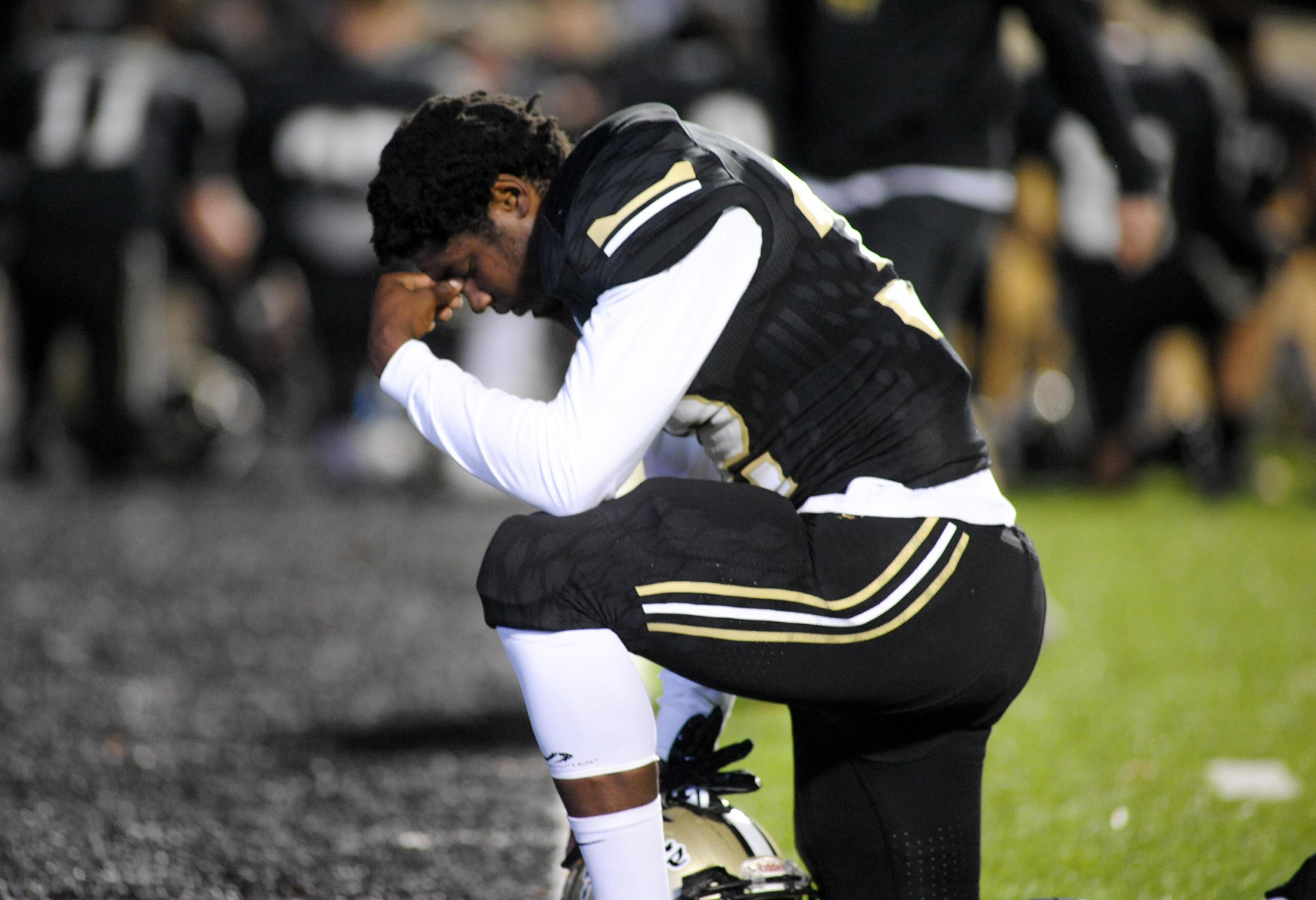 Photo by Mark Gilliland / Calhoun running back Jerrian Hames kneels to pray before a playoff game against Lovett on Nov. 16, 2018.