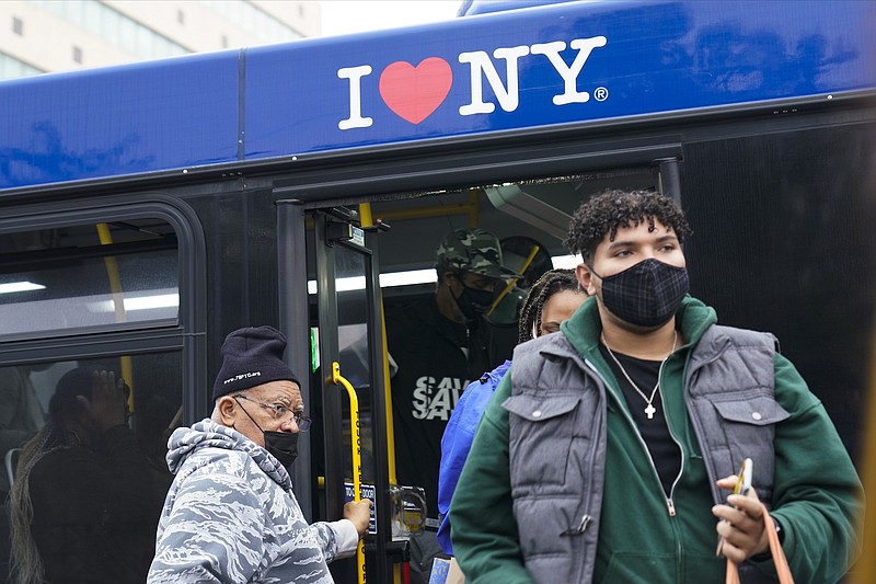 File photo by Frank Franklin II of The Associated Press / People wearing protective masks exit a bus at the Fordham Metro North station on Thursday, Oct. 22, 2020, in New York.