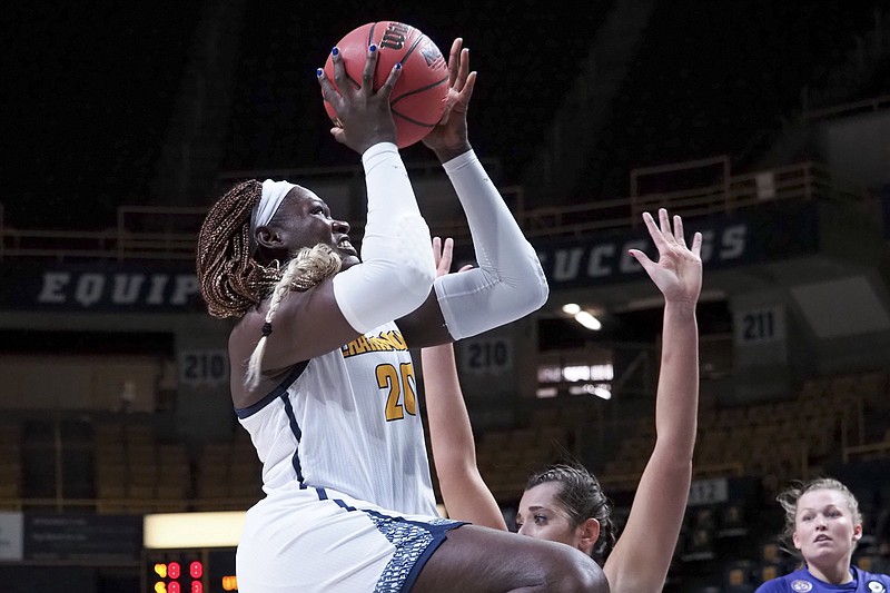 Staff photo by C.B. Schmelter / UTC forward Ruona Uwusiaba (20) draws a foul from Tennessee Tech's Mackenzie Coleman during Friday's game at McKenzie Arena. Uwusiaba came off the bench to score seven points in the Mocs' 76-65 victory, their first win in three games to start the season.