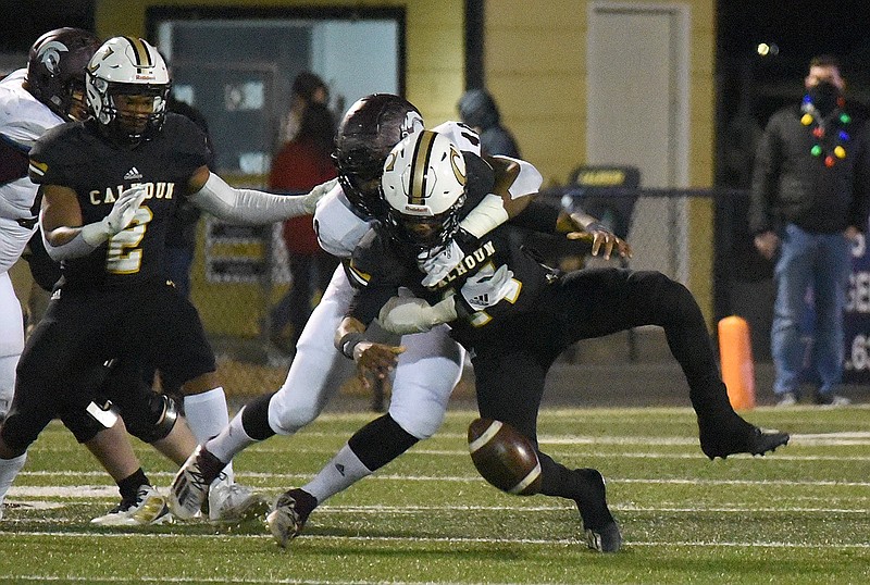 Staff photo by Matt Hamilton / Coffee's Arlis Sutton sacks Calhoun's Christian Lewis, forcing a fumble that was returned for a touchdown during Friday night's GHSA Class AAAAA quarterfinal at Phil Reeve Stadium in Calhoun, Ga. Coffee rallied late to win 27-17.