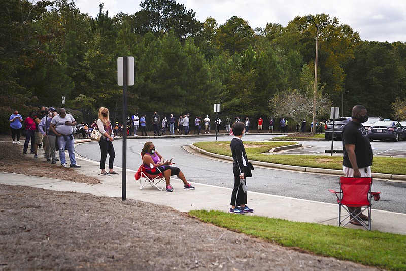 FILE — Waiting in an early voting line on Oct. 12, 2020, at the Georgie Pierce Park Community Center in Suwanee, Ga., part of Gwinnett County outside Atlanta. As the demographics of Atlanta's suburbs have changed, the political leanings have also shifted. (Nicole Craine/The New York Times)