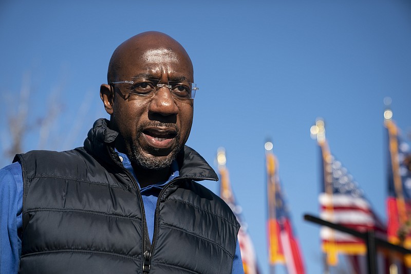 Raphael Warnock, a Democratic candidate for Senate, speaks to reporters at a drive-in rally in Conyers, Ga., Dec. 5, 2020. (Nicole Craine/The New York Times)