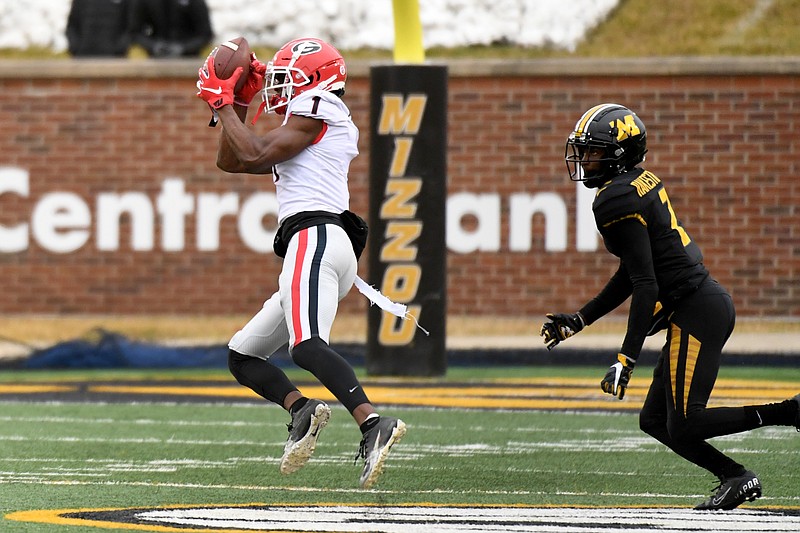 AP photo by L.G. Patterson / Georgia wide receiver George Pickens, left, catches a pass from JT Daniels before running it in for a touchdown with Missouri safety Joshuah Bledsoe trailing during the second half of Saturday's game in Columbia, Mo.