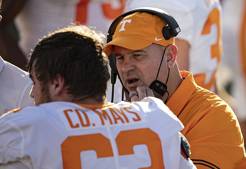 AP photo by Wade Payne / Tennessee football coach Jeremy Pruitt, right, talks with offensive lineman Cooper Mays during the first half of Saturday's game at Vanderbilt.