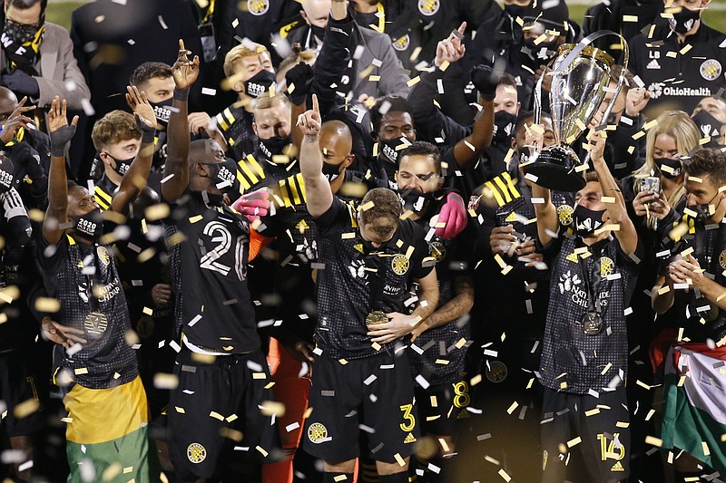 AP photo by Jay LaPrete / Members of the Columbus Crew raise the league championship trophy after defeating the visiting Seattle Sounders 3-0 in the MLS Cup on Saturday.