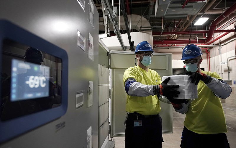 The Associated Press / Workers move boxes containing the Pfizer-BioNTech COVID-19 vaccine to be shipped at the Pfizer Global Supply Kalamazoo manufacturing plant in Portage, Michigan on Sunday, Dec. 13.