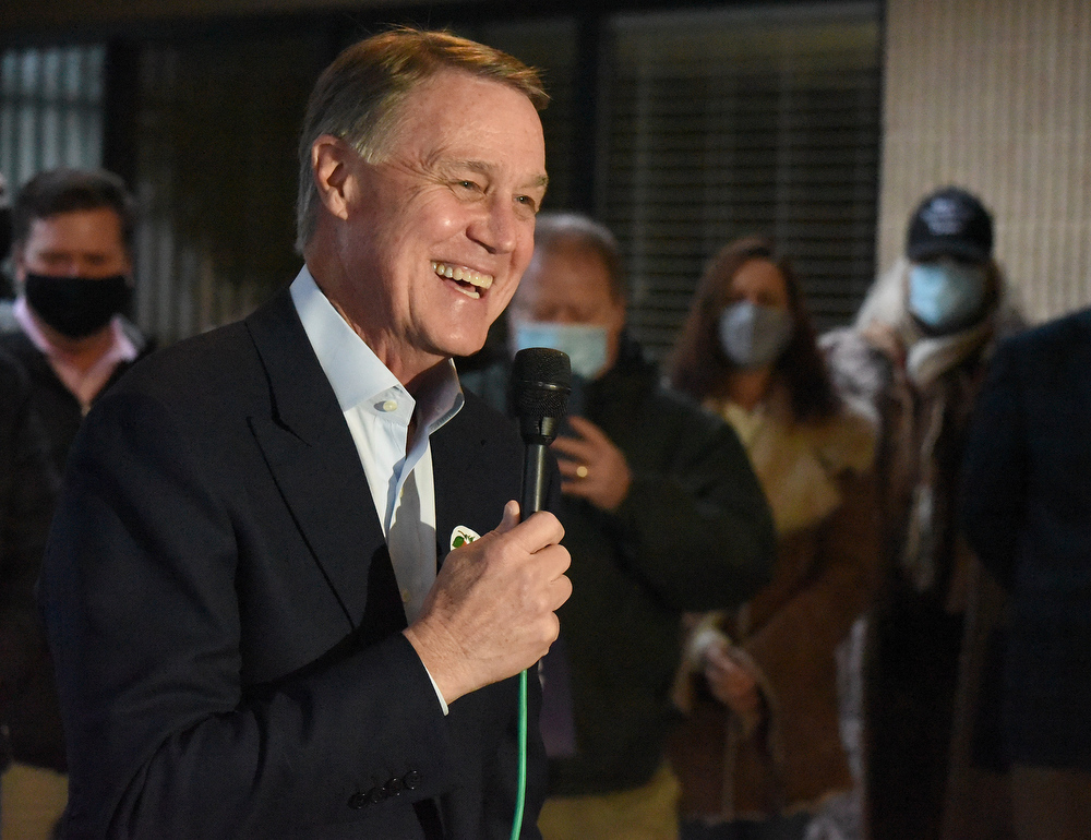Staff Photo by Matt Hamilton / Sen. David Perdue speaks to a crowd of supporters at the Dalton Municipal Airport on Monday, Dec. 14, 2020.