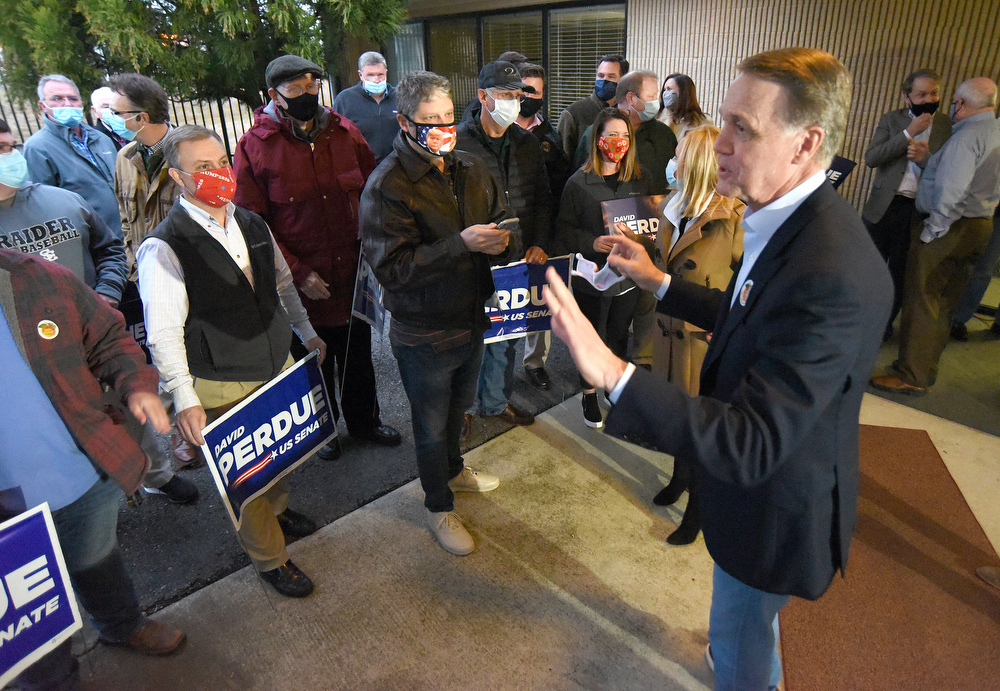 Staff Photo by Matt Hamilton / Sen. David Perdue speaks to a crowd of supporters at the Dalton Municipal Airport on Monday, Dec. 14, 2020.
