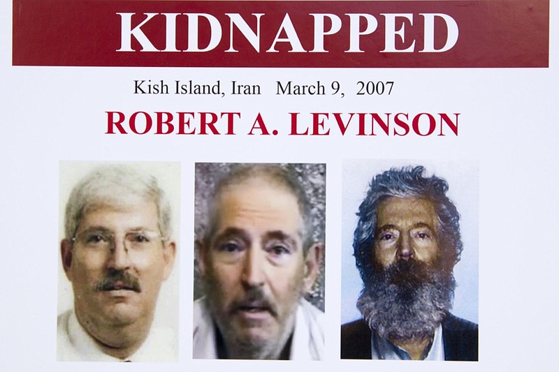 FILE - In this March 6, 2012, file photo, an FBI poster showing a composite image of former FBI agent Robert Levinson, right, of how he would look like now after five years in captivity, and an image, center, taken from the video, released by his kidnappers, and a picture before he was kidnapped, left, displayed during a news conference in Washington. A U.S. judge ordered Iran on Thursday, Oct. 1, 2020, to pay $1.45 billion to Levinson's family, who is believed to have been kidnapped by the Islamic Republic while on an unauthorized CIA mission to an Iranian island in 2007. (AP Photo/Manuel Balce Ceneta, File)