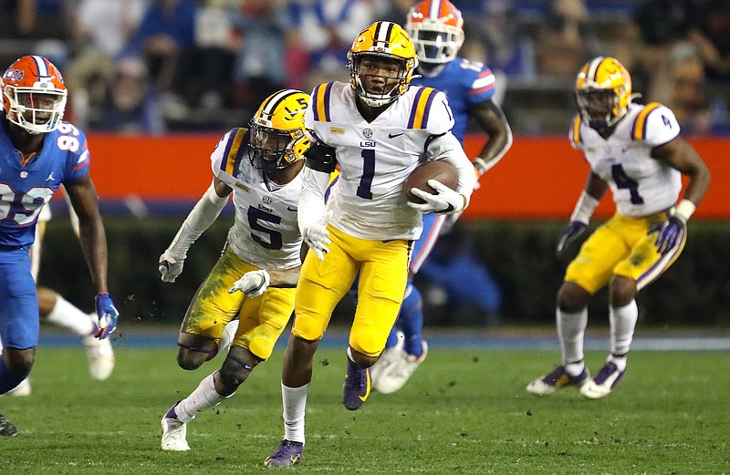 Gainesville Sun photo by Brad McClenny / Defensive back Eli Ricks returns an interception of Kyle Trask 68 yards for a touchdown during LSU's 37-34 upset of Florida last Saturday night in the Swamp.