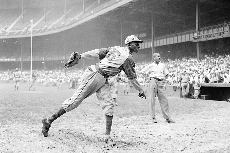 AP photo by Matty Zimmerman / Kansas City Monarchs pitcher Satchel Paige warms up at New York's Yankee Stadium before a Negro Leagues game between the Monarchs and the New York Cuban Stars on Aug. 2, 1942.