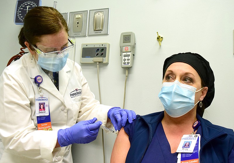 Staff Photo by Robin Rudd / Deborah Deal, RN, Chief Nursing Executive gives Mindy Zychal RN, Medical Intensive Care Manager a vaccination. Parkridge Medical Center began COVID-19 vaccinations today.