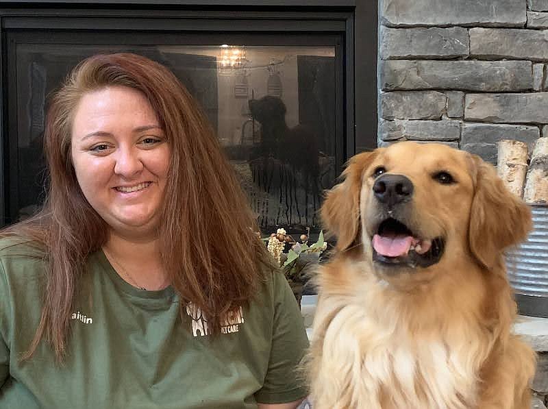 Contributed photo / Kaitlin Wendel, shown with one of the dogs she cares for, has opened a Fetch! Franchise in Chattanooga.