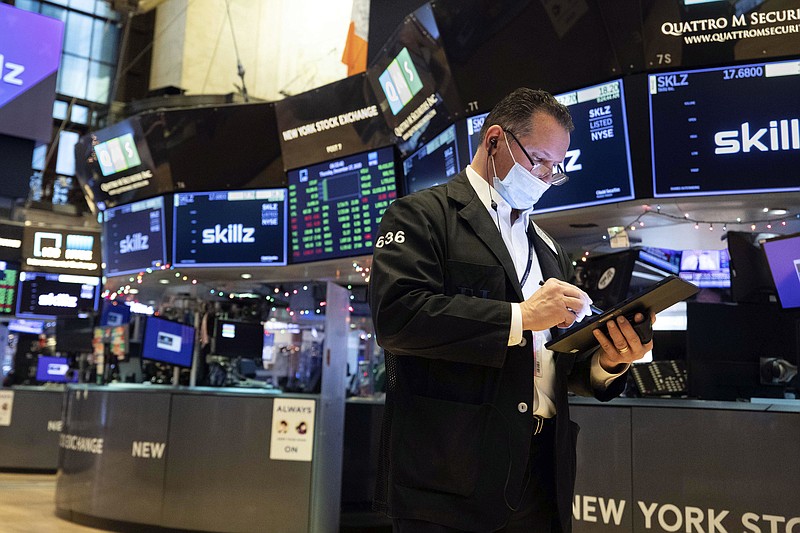 In this photo provided by the New York Stock Exchange, trader Edward Curran works on the floor, Thursday, Dec. 17, 2020. Stocks rose in morning trading as investors remain optimistic that Washington will deliver another round of financial support for the economy as vaccines begin slowly rolling out to the public.(Colin Ziemer/New York Stock Exchange via AP)