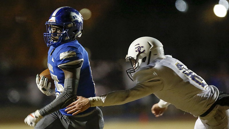 Staff photo by C.B. Schmelter / Red Bank's Lumiere Strickland gets past Sequatchie County's Austin Moffitt to score a touchdown during a first-round game in the TSSAA Class 3A playoffs on Nov. 8 in Red Bank. Strickland was voted Region 3-3A MVP this season, while Moffitt was an All-Region 4-3A first-team selection.