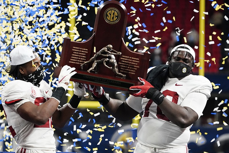 AP photo by Brynn Anderson / Alabama running back Najee Harris, left, and offensive lineman Alex Leatherwood celebrate after the Crimson Tide beat Florida 52-46 to win the SEC title Saturday night at Mercedes-Benz Stadium in Atlanta.