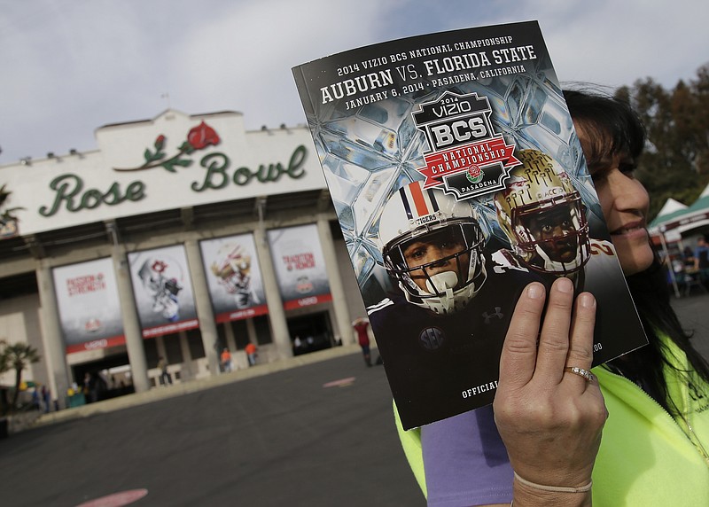AP photo by Chris Carlson / A vendor sells a program outside the Rose Bowl on Jan. 6, 2014, in Pasadena, Calif.