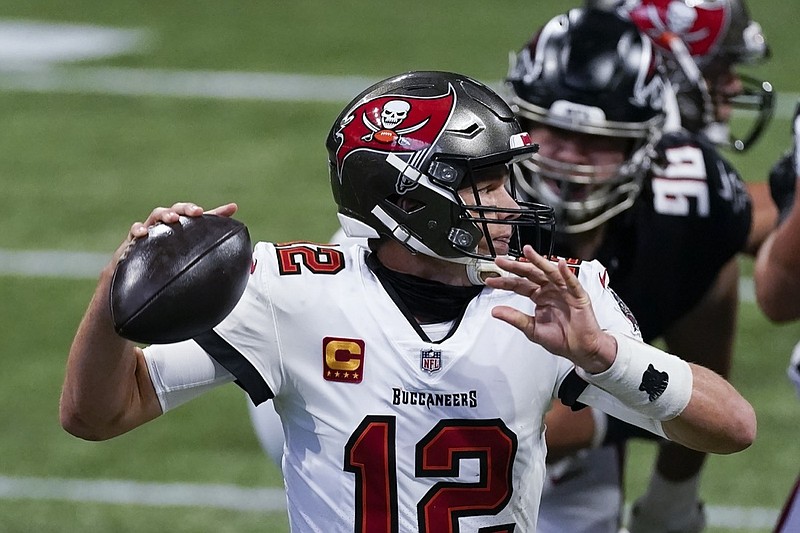 Tampa Bay Buccaneers quarterback Tom Brady (12) works in the pocket as Atlanta Falcons defensive tackle Tyeler Davison (96) gives pressure during the first half of an NFL football game, Sunday, Dec. 20, 2020, in Atlanta. (AP Photo/John Bazemore)