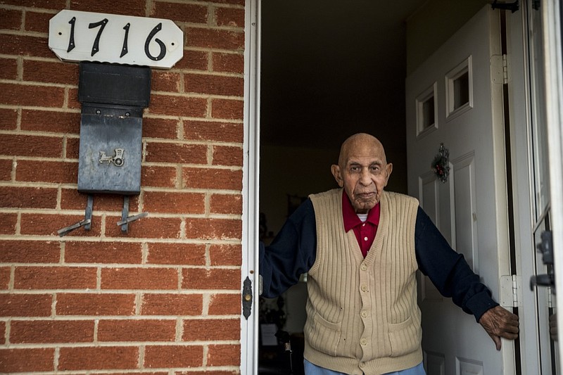 FILE - In this Wednesday, Dec. 9, 2020, file photo, Alfred Farrar, a Tuskegee Airman who is celebrating his 100th birthday in December, poses for a portrait in the doorway of his home in Lynchburg, Va. Farrar died on Thursday, Dec. 17, 2020, in Virginia, only days before a ceremony planned to honor his service in the program that famously trained Black military pilots during World War II. He was 99. Farrar's 100th birthday would've been on Dec. 26. (Kendall Warner/The News & Advance via AP, File)