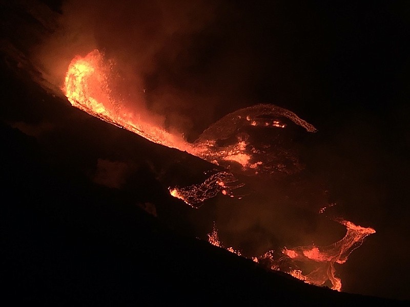 In this photo provided by the U.S. Geological Survey, lava flows within the Halema'uma'u crater of the Kilauea volcano Sunday, Dec. 20, 2020. The Kilauea volcano on Hawaii's Big Island has erupted, the U.S. Geological Survey said. (U.S. Geological Survey via AP)