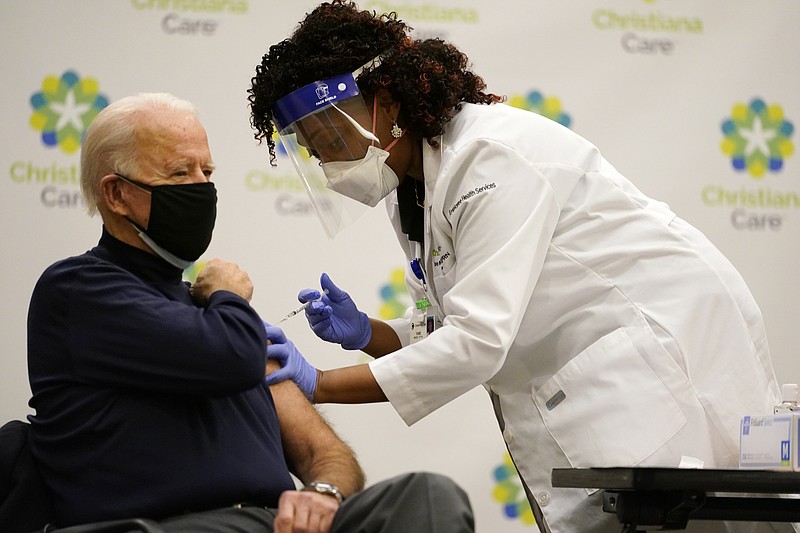 President-elect Joe Biden receives his first dose of the coronavirus vaccine at ChristianaCare Christiana Hospital in Newark, Del., Monday, Dec. 21, 2020, from nurse practitioner Tabe Mase. (AP Photo/Carolyn Kaster)
