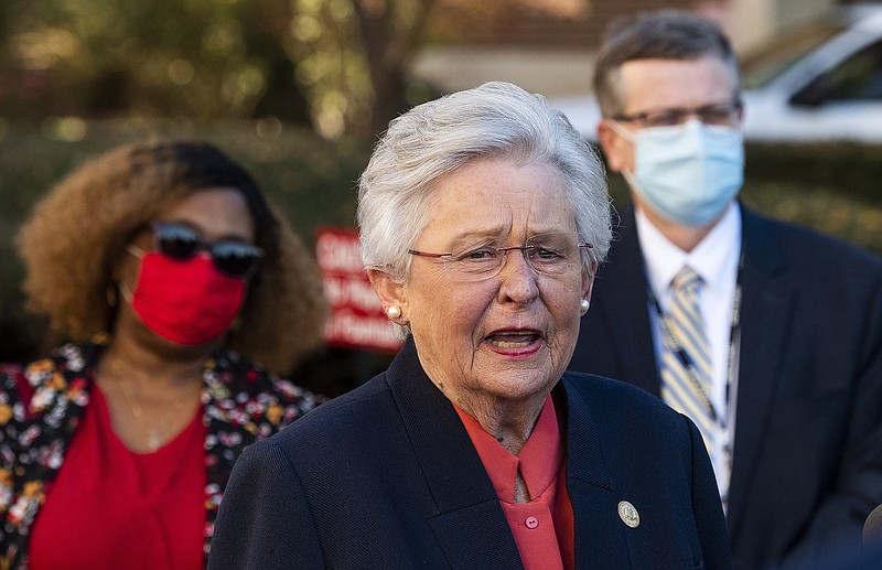 Alabama Governor Kay Ivey, backed by State Chief Medical Officer Dr. Mary McIntyre, left, and State Health Officer Dr. Scott Harris, right, speaks with the media after receiving her COVID-19 vaccine at Baptist Medical Center South in Montgomery, Ala., on Monday, Dec. 21, 2020. (Mickey Welsh/The Montgomery Advertiser via AP)