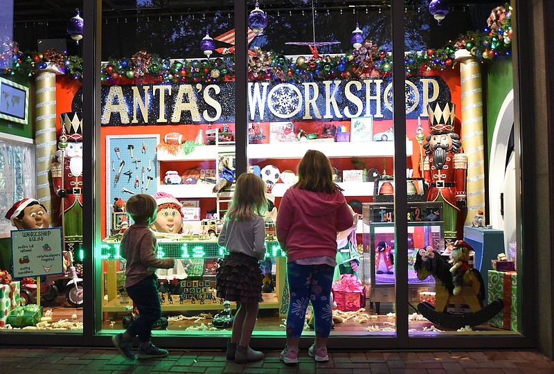 Staff Photo by Matt Hamilton / Jane Hangstefer, 5, center, looks at the windows with her cousins Thomas Sedman, 2, left, and Kelly Grace Sedman, 5, at the EPB building in downtown Chattanooga.