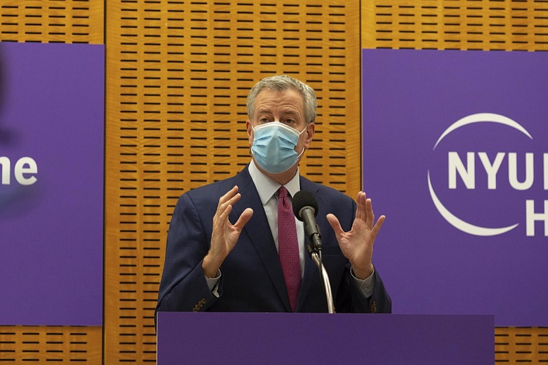 Mayor Bill de Blasio delivers remarks ahead of the first COVID-19 vaccinations at NYU-Langone Hospital on Monday, Dec. 14, 2020, in New York. Hundreds of thousands of health care workers across the country are expected to receive the vaccine this week. (AP Photo/Kevin Hagen).