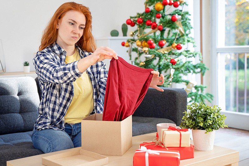 Disappointed customer unboxing Christmas gift, home shopping. / Photo credit: Getty Images/iStock/tommaso79 