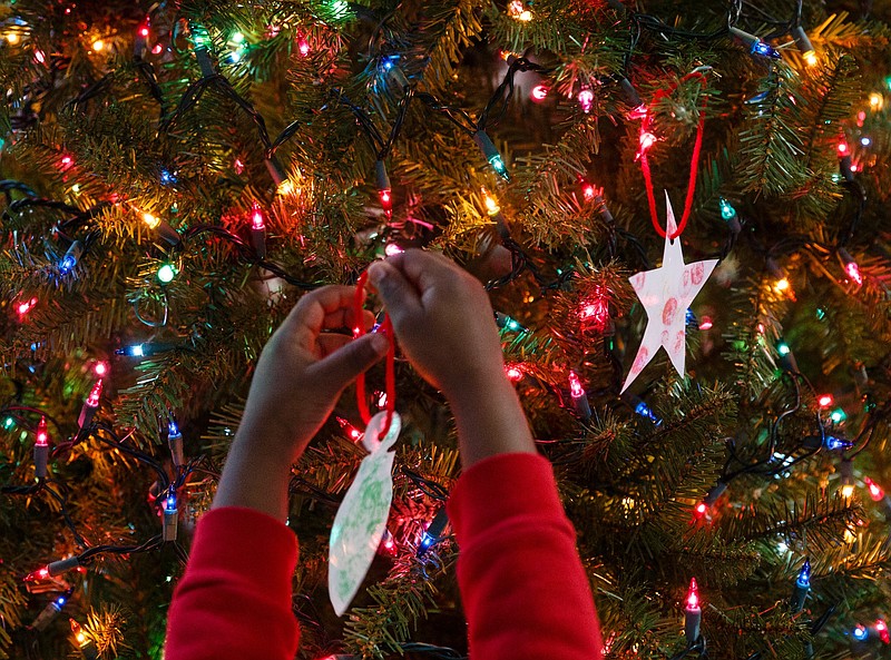 Staff file photo by Doug Strickland / A child decorates a Christmas tree during a 2018 visit to the Tennessee Valley Authority's downtown headquarters.