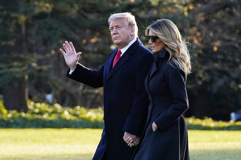 President Donald Trump and first lady Melania Trump walk to board Marine One on the South Lawn of the White House, Wednesday, Dec. 23, 2020, in Washington. (AP Photo/Evan Vucci)