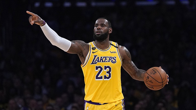 AP file photo by Mark J. Terrill / Los Angeles Lakers forward LeBron James is the AP's male athlete of the year for 2020, his fourth time receiving the honor. That ties the record held by Lance Armstrong and Tiger Woods.