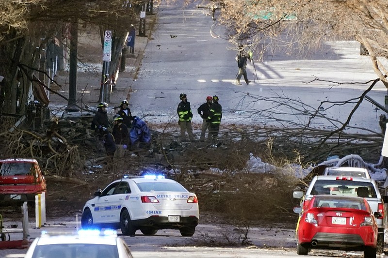 Investigators continue to examine the site of an explosion Sunday, Dec. 27, 2020, in downtown Nashville, Tenn. An explosion that shook the largely deserted streets of downtown Nashville early Christmas morning shattered windows, damaged buildings and wounded multiple people. Authorities said they believed the blast was intentional. (AP Photo/Mark Humphrey)