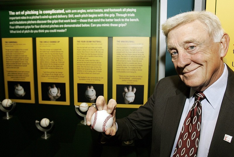 AP file photo by Tony Dejak / Former Atlanta Braves pitcher Phil Niekro demonstrates how to hold a knuckleball on March 29, 2007, at the Great Lakes Science Center in Cleveland. Niekro, who played in the majors well into his 40s and was inducted into the National Baseball Hall of Fame in 1997, died Saturday night at the age of 81 after a lengthy bout with cancer.