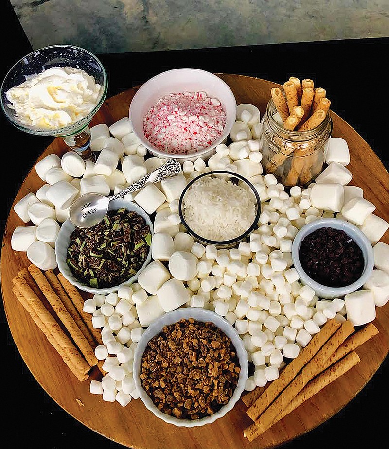 Contributed Photo by Christie Johnson / Using a 20-inch by 20-inch cutting board, Christie Johnson covered its surface with a variety of marshmallows and cups she already had on hand to hold coconut, mint chocolate pieces, whipped cream, peppermint and toffee shavings. Guests could choose their favorites to customize their cocoa.