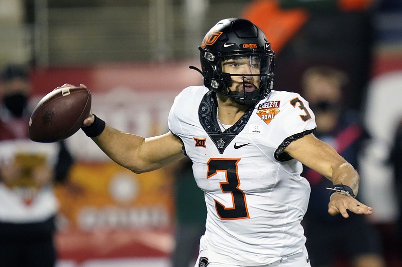 Oklahoma State quarterback Spencer Sanders (3) throws a pass against Miami during the second half of the Cheez-it Bowl NCAA college football game, Tuesday, Dec. 29, 2020, in Orlando, Fla. (AP Photo/John Raoux)