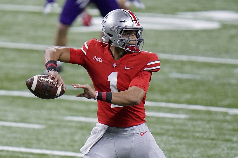 AP file photo by AJ Mast / Ohio State quarterback Justin Fields has the Buckeyes back in the College Football Playoff and facing a familiar postseason foe in Clemson at the Sugar Bowl.