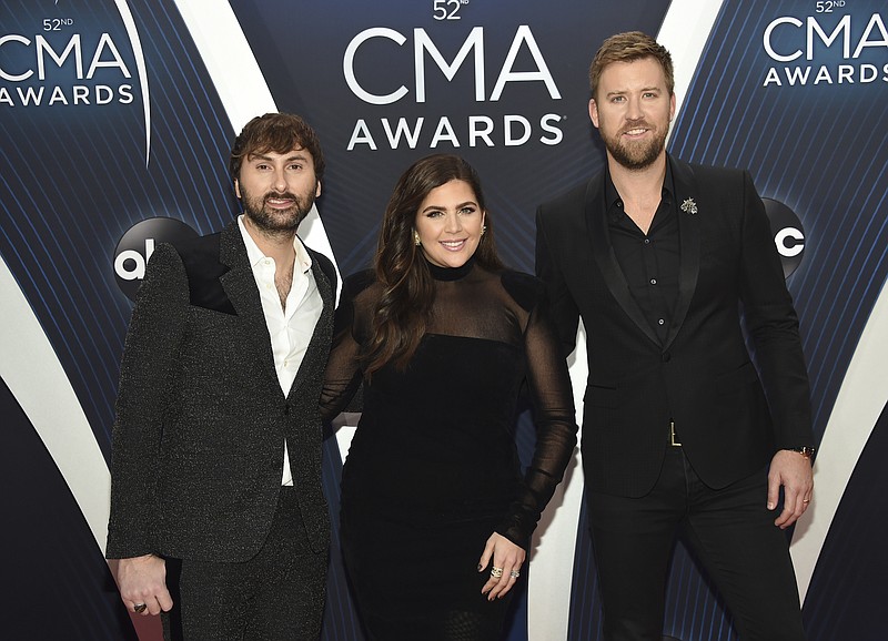 File photo by Evan Agostini/Invision/The Associated PRess / In this Nov. 14, 2018 file photo, Dave Haywood, from left, Hillary Scott and Charles Kelley, of Lady A, formerly Lady Antebellum, arrive at the 52nd annual CMA Awards in Nashville, Tennessee. The Grammy-winning country group dropped the word "Antebellum" from their name because of the word's ties to slavery.