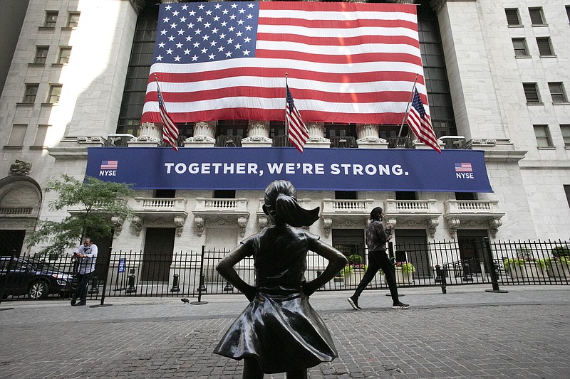 FILE - In this July 9, 2020 file photo, the Fearless Girl statue stands in front of the New York Stock Exchange in New York. Stocks are off to a mixed start, Thursday, Dec. 31, on Wall Street on the last day of 2020, a year that saw a breathtaking nosedive in markets in the spring as the coronavirus took hold followed by steady gains in the months that followed as hopes built for an eventual return to something like normal. (AP Photo/Mark Lennihan, File)