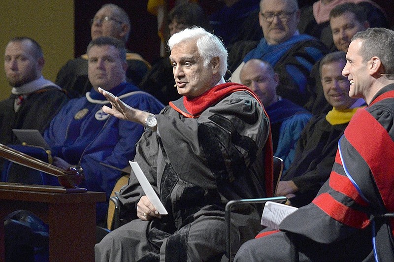 FILE - In this March 30, 2016 file photo, Ravi Zacharias, center, speaks during the Society of World Changers induction ceremony at Indiana Wesleyan University in Marion, Ind. Zacharias, who built an international ministry that strives to defend Christianity on intellectual grounds, died Tuesday, May 19, 2020 at his home in Atlanta after a brief battle with sarcoma, Ravi Zacharias International Ministries said in a statement. (Jeff Morehead/The Chronicle-Tribune via AP)

