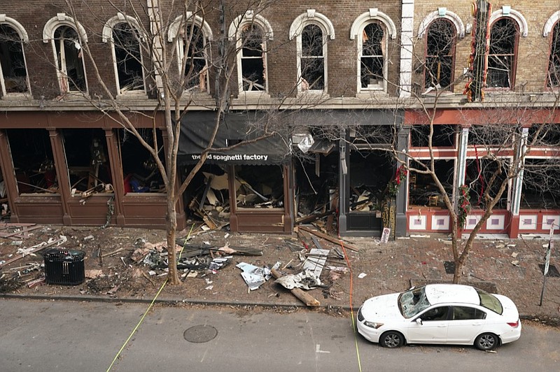 FILE - In this Dec. 29, 2020 file photo, debris remains on the sidewalk in front of buildings damaged in a Christmas Day explosion in Nashville, Tenn. The Christmas Day bombing in downtown Nashville led to communications outages over hundreds of miles in the southern U.S., raising concerns about the vulnerability of U.S. networks. Widespread service outages followed the explosion, which damaged a major AT&T network hub, extended hundreds of miles to at least four neighboring states, disrupting 911 call centers, hospitals and flights out of the Nashville airport. (AP Photo/Mark Humphrey, File)


