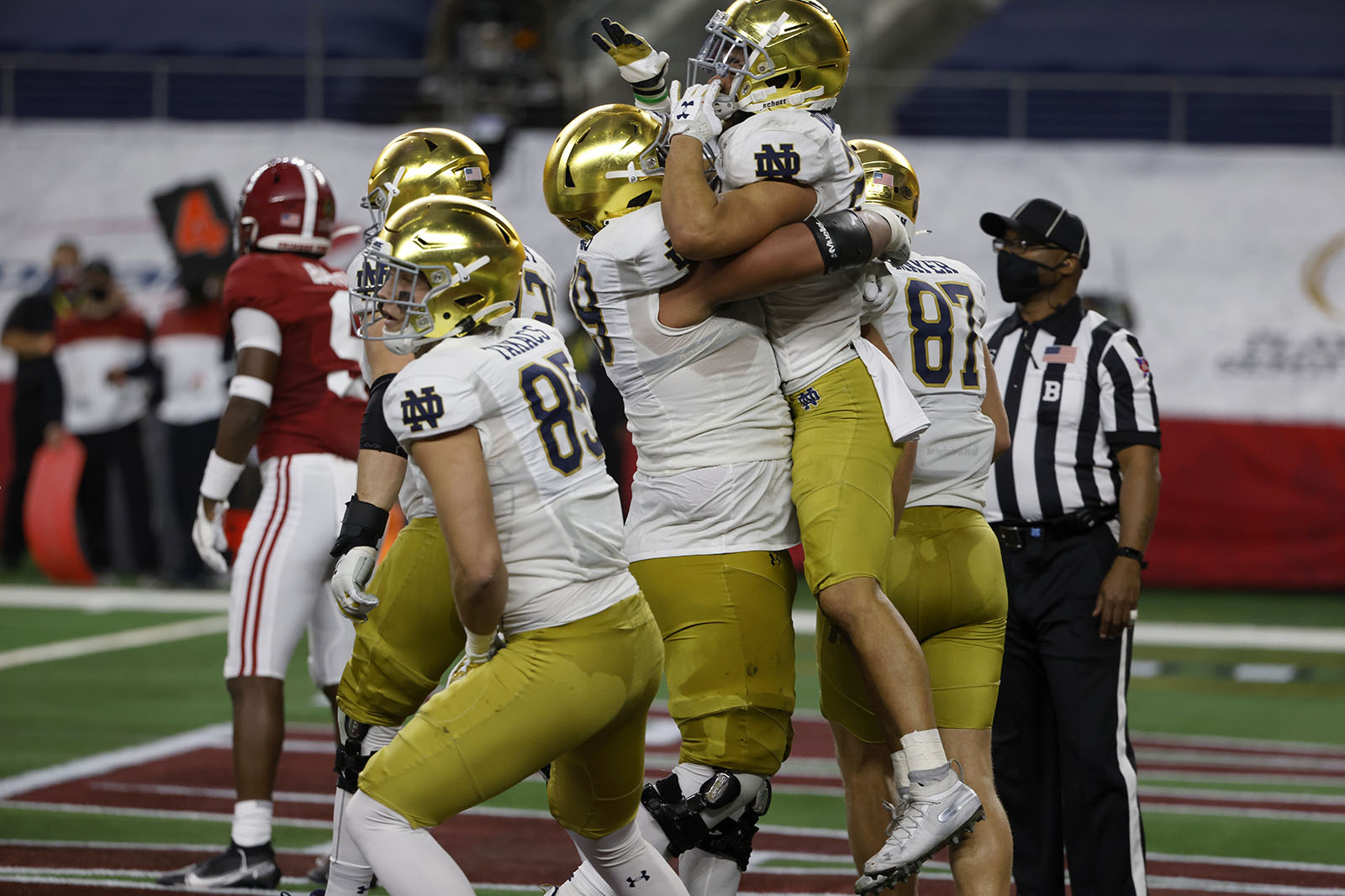 Notre Dame running back Kyren Williams, being lifted, celebrates with tight end George Takacn (85) and tight end Michael Mayer (87) and others after scoring a touchdown on a run in the first half of the Rose Bowl NCAA college football game against Alabama in Arlington, Texas, Friday, Jan. 1, 2021. (AP Photo/Ron Jenkins)