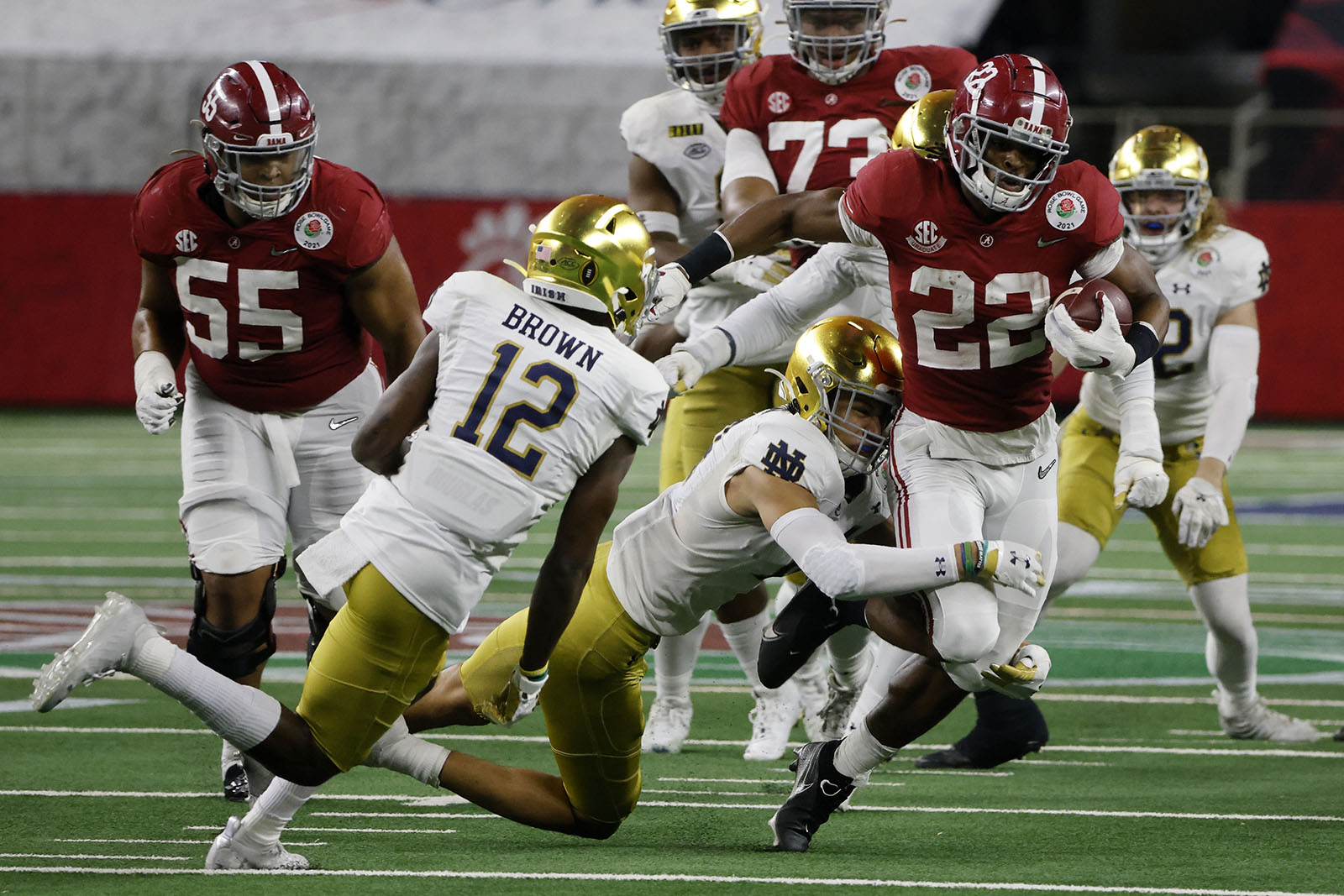 Notre Dame safety DJ Brown (12) and others attempt to stop Alabama running back Najee Harris (22) in the second half of the Rose Bowl NCAA college football game in Arlington, Texas, Friday, Jan. 1, 2021. (AP Photo/Michael Ainsworth)