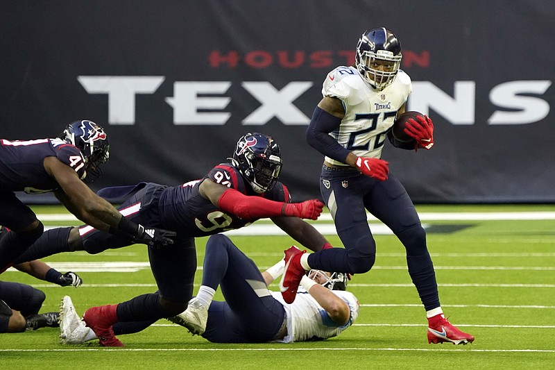 AP photo by Sam Craft / Tennessee Titans running back Derrick Henry (22) breaks away from Houston Texans defensive end Charles Omenihu during the second half of Sunday's game in Houston. Henry rushed for 250 yards on 34 carries to finish the regular season with 2,027 yards on the ground and set a franchise record, and the Titans won 41-38 to earn their first division title since the 2008 season.