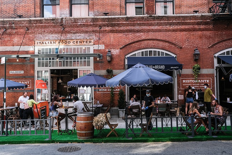 In 2020, the best seat in the house wasn't a see-and-be-seen "display table" or a secluded corner booth. Prime seating was anywhere outside, even in a parking lot — the farther away from other people, the better. / Photo by Byron Smith/Getty Images/TNS