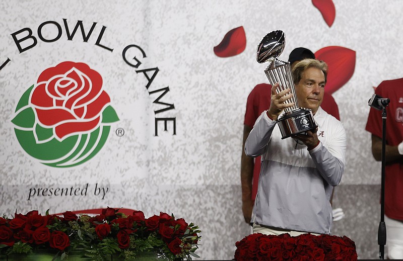 Crimson Tide photos / Alabama football coach Nick Saban holds up the Rose Bowl trophy following last Friday's 31-14 defeat of Notre Dame. Saban will coach in Monday's national championship game against Ohio State for the final time with offensive coordinator Steve Sarkisian, who has been introduced as the new head coach at Texas.