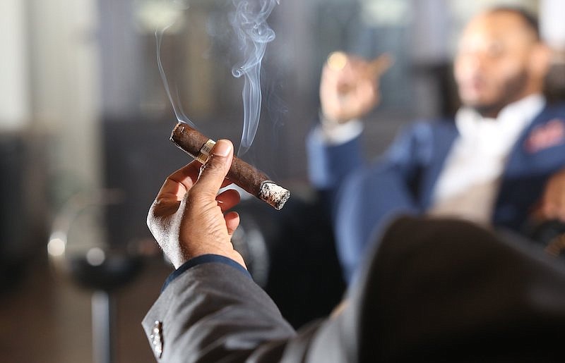 Staff file photo / Chris Abernathy Sr. of Chattanooga Cigars for Gents holds his burning cigar at Burns Tobacconist Saturday, April 13, 2019 in Chattanooga, Tenn.