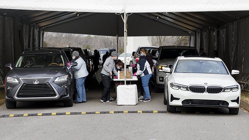 Staff photo by C.B. Schmelter / Hamilton County Health Department workers dispense doses of the COVID-19 vaccine near the Hubert Fry Center at the Tennessee Riverpark on Wednesday, Dec. 30, 2020, in Chattanooga, Tenn.