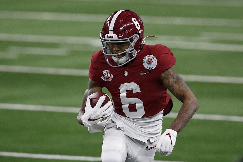 Alabama wide receiver DeVonta Smith (6) gains yardage after a catch in the first half of the Rose Bowl NCAA college football game against Notre Dame in Arlington, Texas, Friday, Jan. 1, 2021. (AP Photo/Roger Steinman)