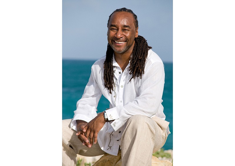 This undated image released by Joseph Jones shows author Eric Jerome Dickey in Antigua. Dickey, the bestselling novelist who blended crime, romance and eroticism in "Sister, Sister," "Waking With Enemies" and dozens of other stories about contemporary Black life, has died at age 59. Dickey's publicist at Penguin Random House, Emily Canders, told The Associated Press that the author died Sunday, Jan. 3, 2021 in Los Angeles after a long illness. (Joseph Jones via AP)